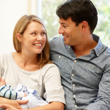 couple at home with new baby