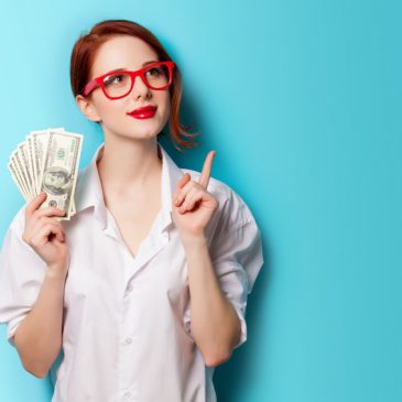portrait of redhead women in red glasses with money on blue background