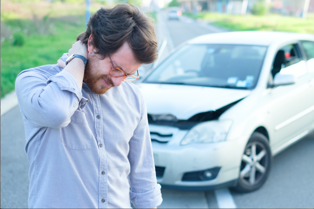 man-rubbing-neck-after-car-crash