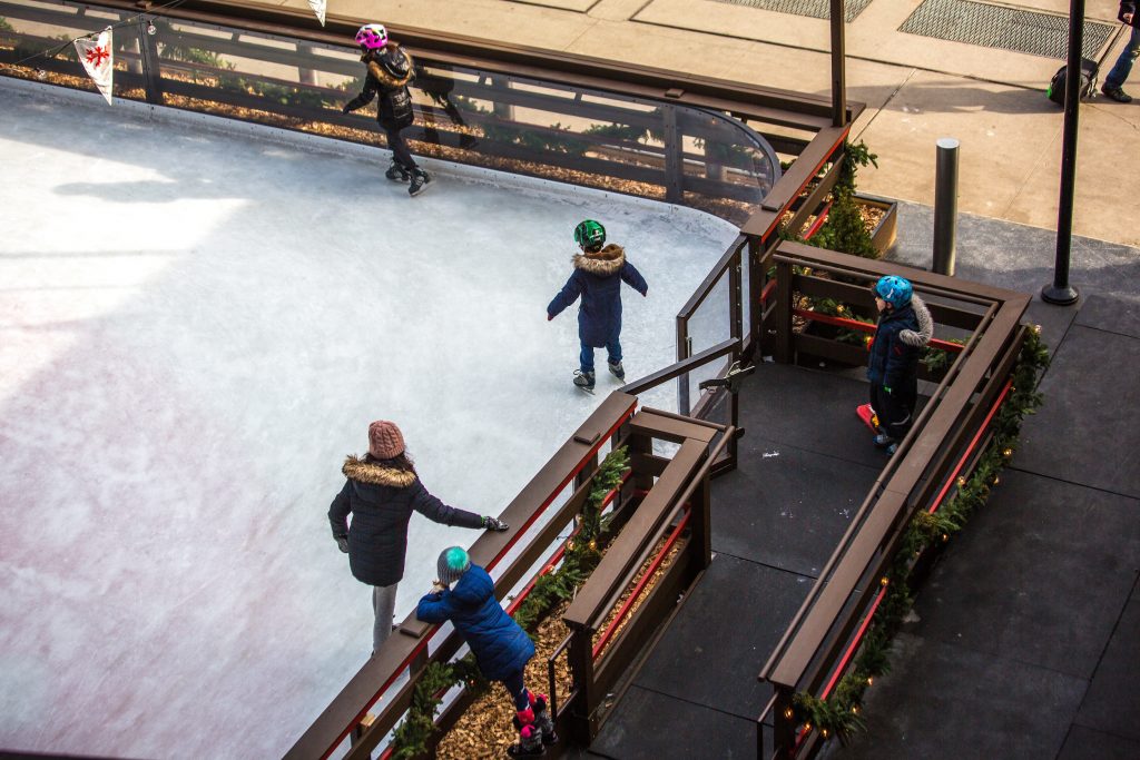 family-ice-skating-in-holiday-ice-rink