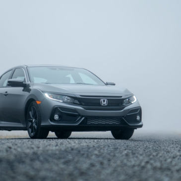 a gray Honda is parked in the fog