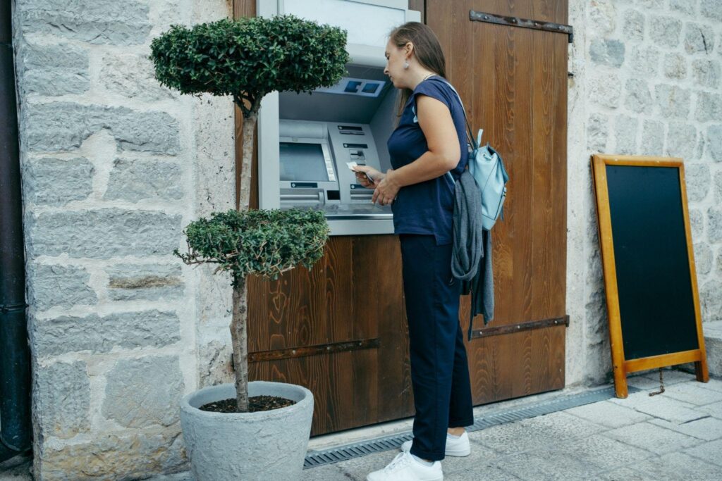 A woman accesses an ATM